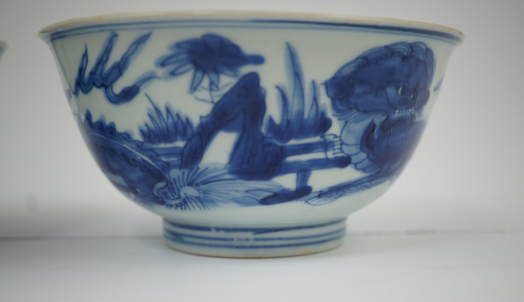 A pair of Chinese Transitional blue and white 'mythical beasts' bowls, early Kangxi period